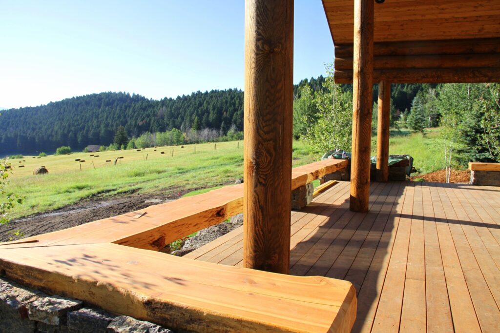 handcrafted log home porch looking at rolling hills and mountains