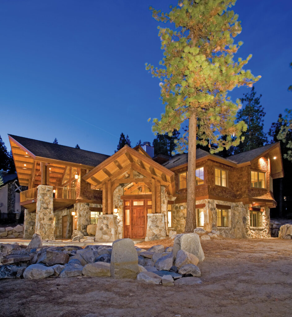 exterior timberframe log home at dusk with exterior lighting